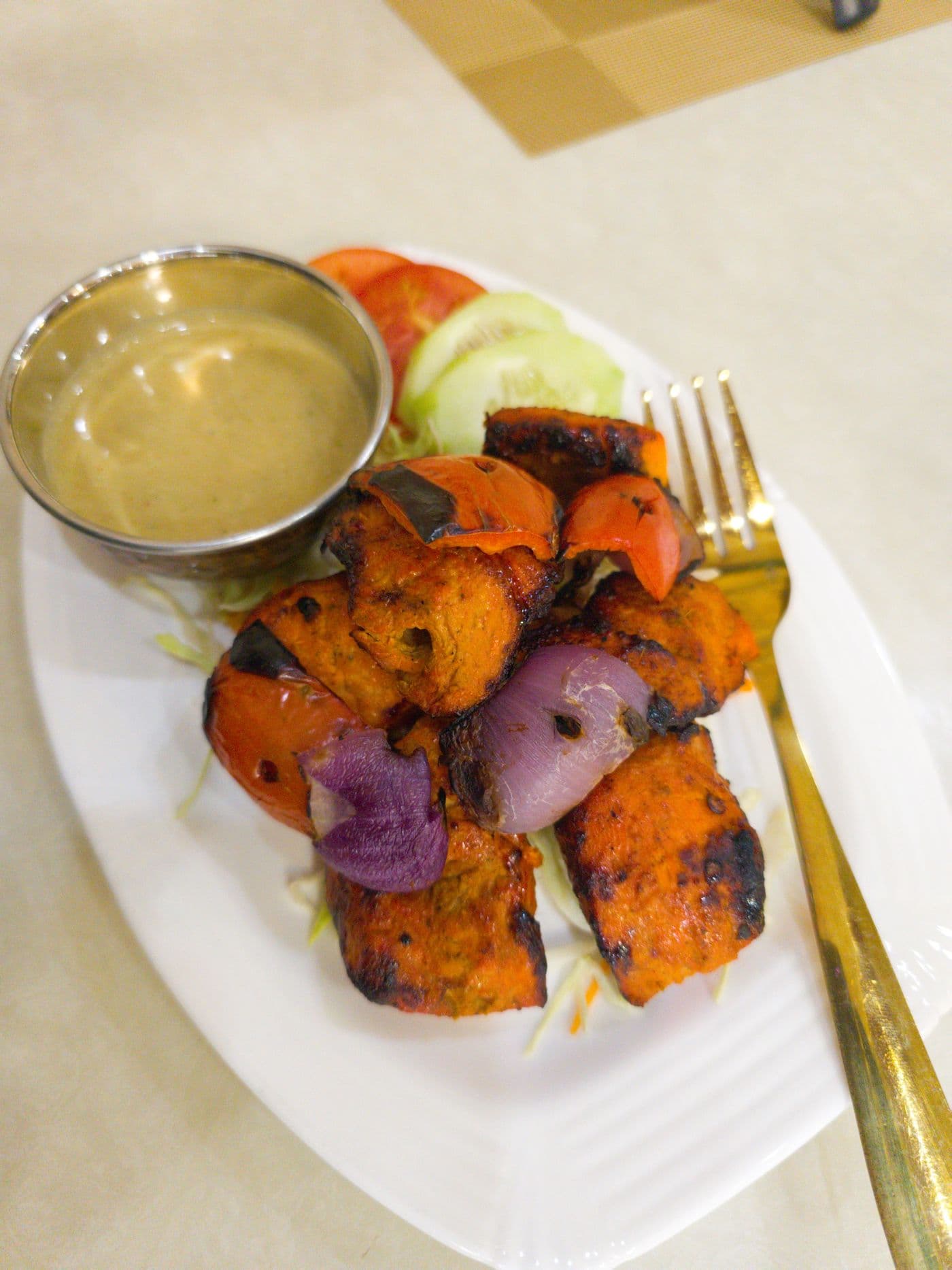 Chicken Tikka served with grilled vegetables and a creamy dip at Little Asia