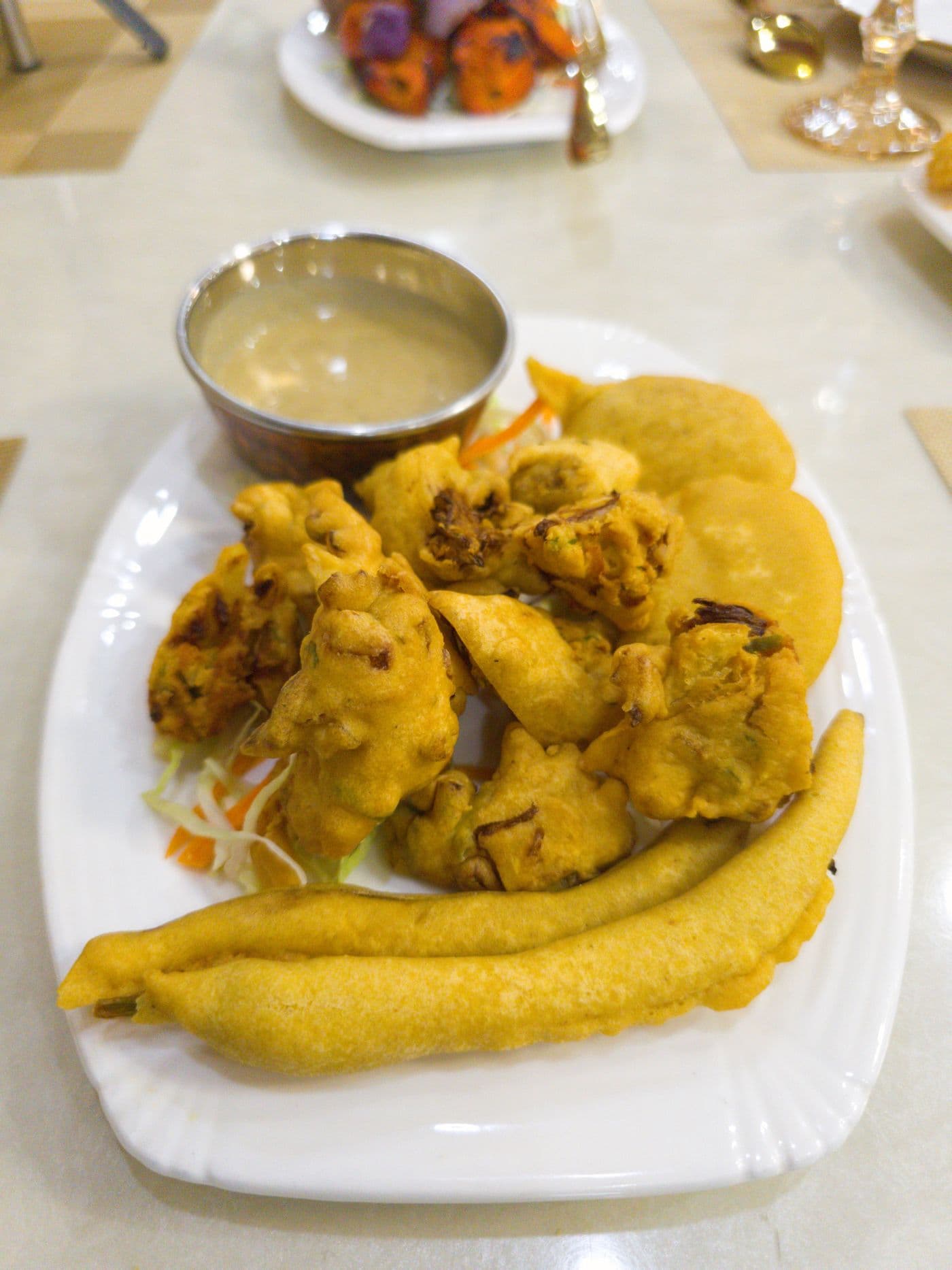 Veg Pakora with a dipping sauce at Little Asia Bar and Restaurant